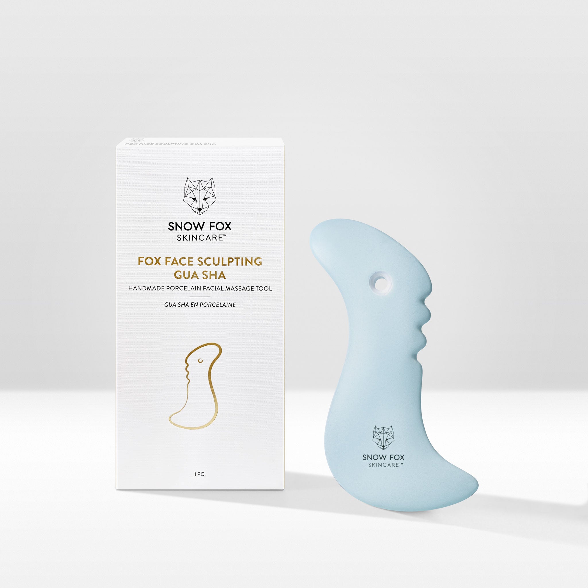 A fine porcelain, facial slimming Gua Sha specially designed by reflexologists to reach lymphatic drainage points under the chin to minimize bloating and sagging, naturally lifting and contouring the face especially around the jawline.