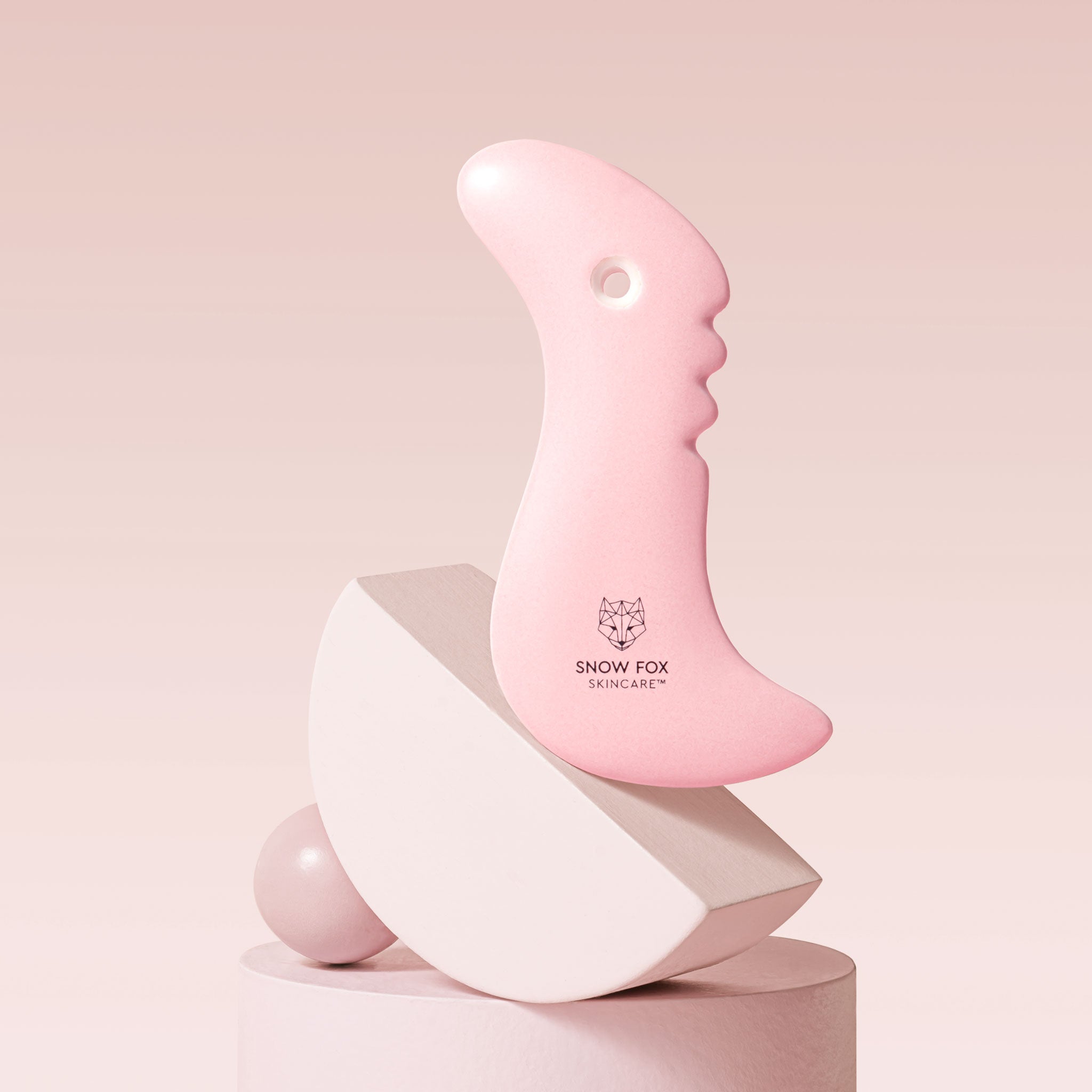 A fine porcelain, facial slimming Gua Sha specially designed by reflexologists to reach lymphatic drainage points under the chin to minimize bloating and sagging, naturally lifting and contouring the face especially around the jawline.